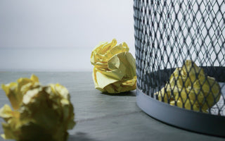 Yellow paper waste in an office bin. 